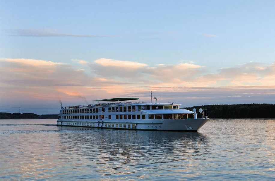 River cruise ship sailing on a calm European river at sunset - are river cruises safe