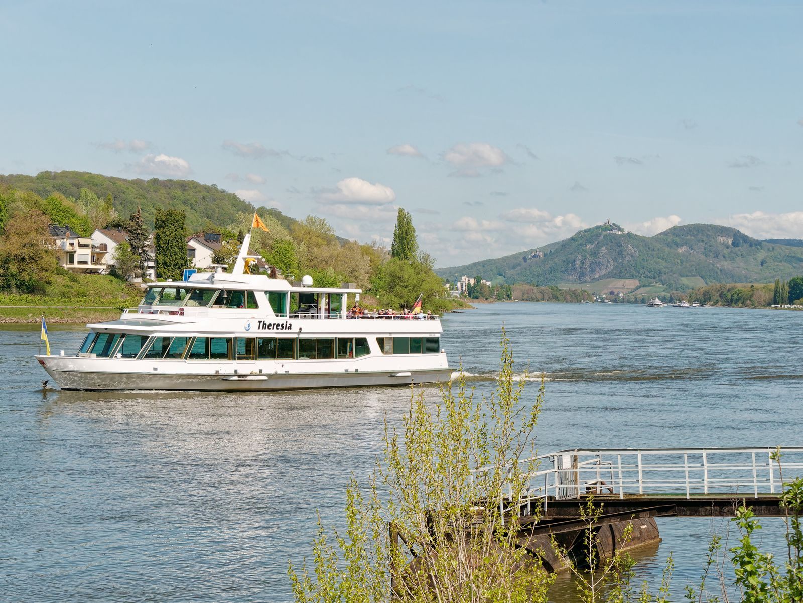 Passenger ship on the Rhine near Unkel with green hills close on both banks